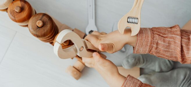 child with toy blocks and tools